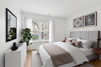 Bedroom with upholstered headboard and geometric wall art